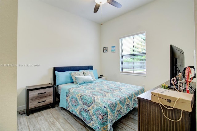bedroom with a ceiling fan and wood finished floors