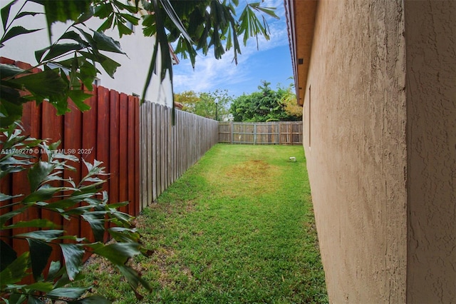 view of yard with a fenced backyard