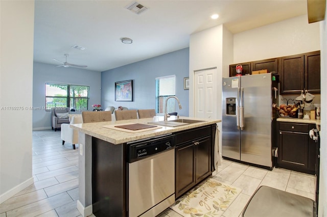 kitchen featuring a sink, light countertops, a healthy amount of sunlight, and stainless steel appliances