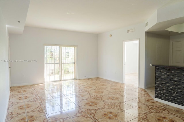 spare room with visible vents and baseboards