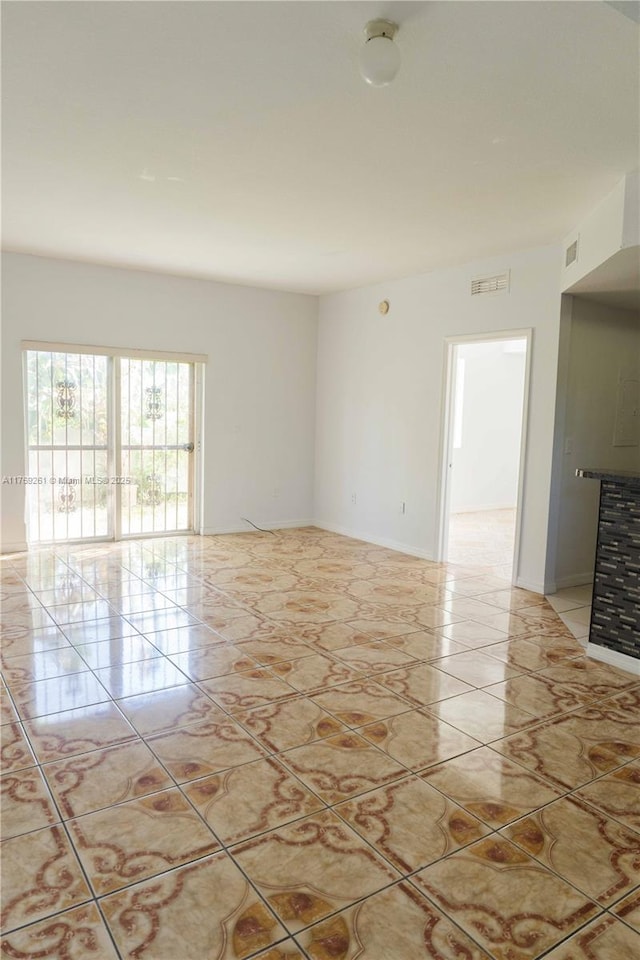 unfurnished room with baseboards and marble finish floor