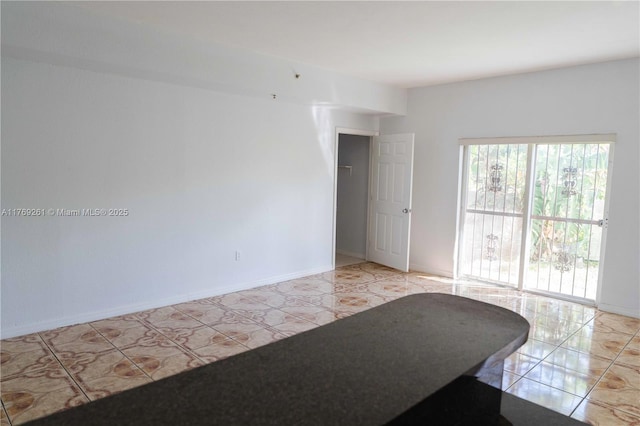 empty room featuring baseboards