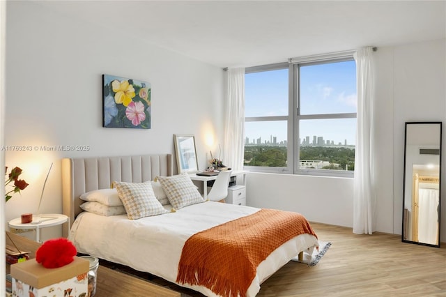 2899 Collins Ave Unit 1638, Miami Beach, FL 33140 - bedroom featuring light wood-style flooring and a skyline view