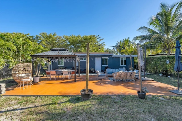 back of property with an outdoor hangout area, a gazebo, and a patio area
