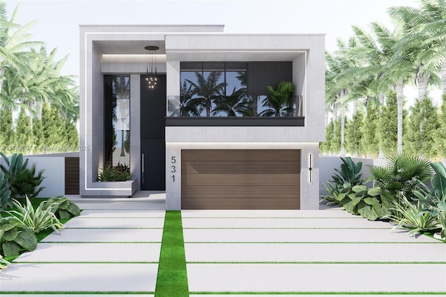 view of front of house with driveway, stucco siding, and an attached garage
