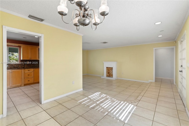 unfurnished room with an inviting chandelier, light tile patterned floors, and visible vents