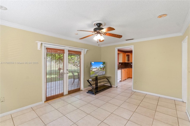 empty room with a textured ceiling, light tile patterned floors, ornamental molding, and a ceiling fan