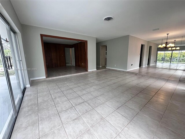 10475 SW 96th Ter, Kendall, FL 33176 - spare room featuring a chandelier, visible vents, baseboards, and light tile patterned floors