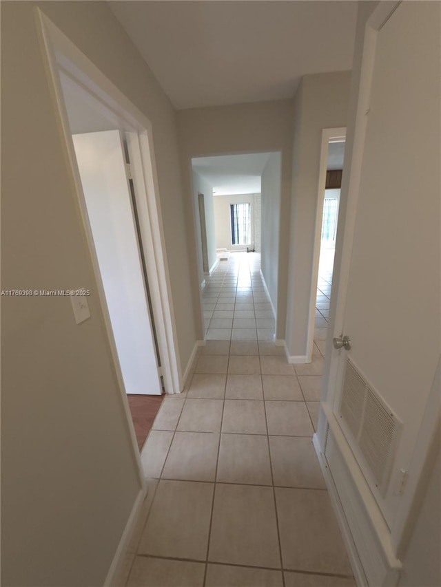 10475 SW 96th Ter, Kendall, FL 33176 - hall with baseboards, visible vents, and light tile patterned floors