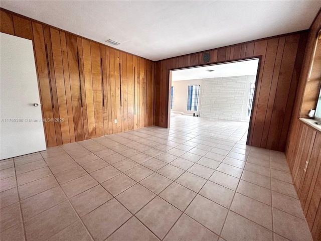 10475 SW 96th Ter, Kendall, FL 33176 - empty room featuring visible vents, wood walls, and light tile patterned floors