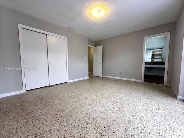 10475 SW 96th Ter, Kendall, FL 33176 - unfurnished bedroom with speckled floor, baseboards, visible vents, and a closet