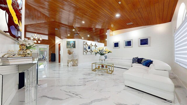 living room featuring visible vents, marble finish floor, lofted ceiling, an inviting chandelier, and wood ceiling