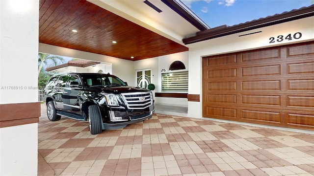 garage featuring decorative driveway