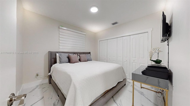bedroom with marble finish floor, a closet, baseboards, and visible vents