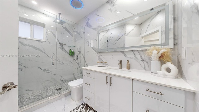 full bathroom featuring vanity, a marble finish shower, stone wall, toilet, and marble finish floor