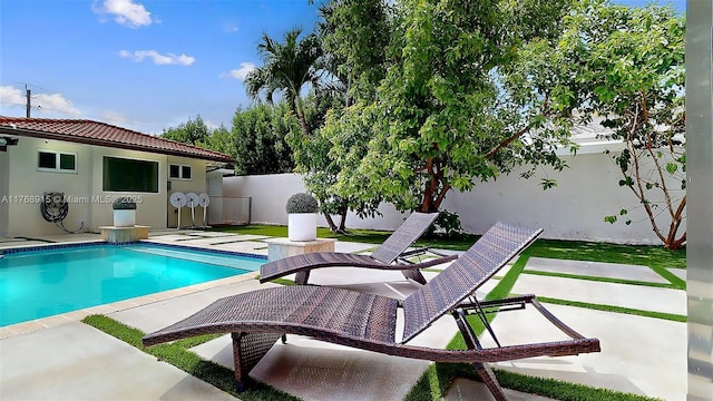 view of pool with a fenced backyard, a fenced in pool, and a patio area