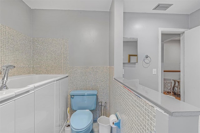 2525 SW 86th Ave, Davie, FL 33324 - bathroom with tile walls, visible vents, and toilet