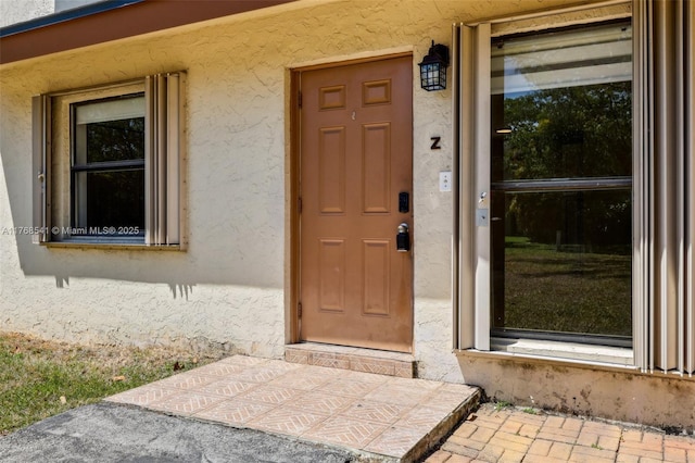 property entrance featuring stucco siding