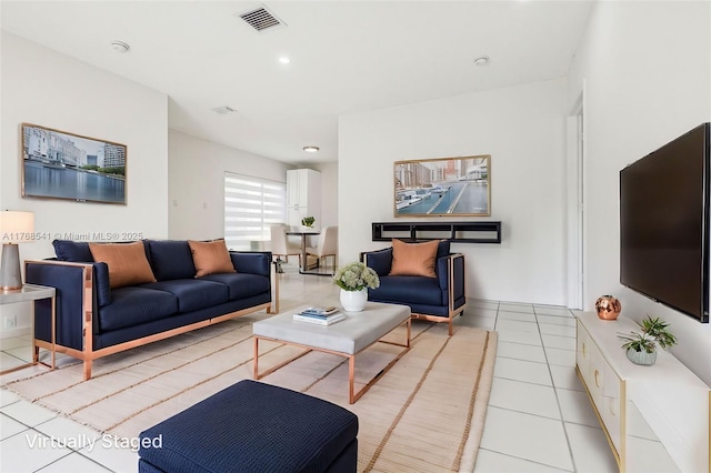 living area featuring light tile patterned flooring, visible vents, and recessed lighting