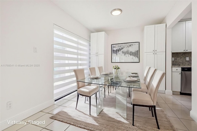 dining area featuring light tile patterned floors and baseboards