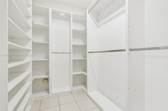 spacious closet featuring light tile patterned floors