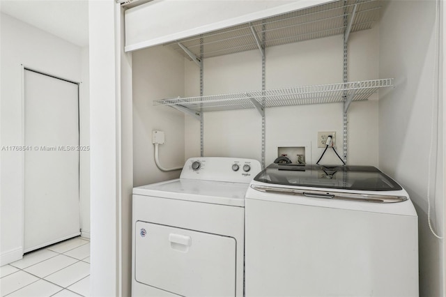 laundry room featuring light tile patterned floors, washer and dryer, and laundry area
