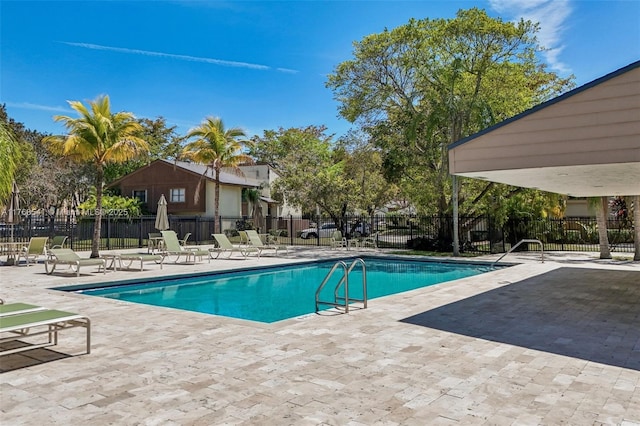 pool with fence and a patio