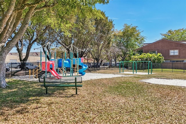 community play area with a lawn and fence