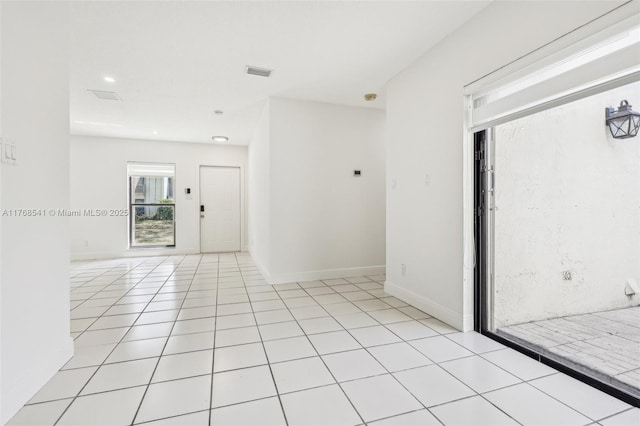 spare room with light tile patterned floors, baseboards, and visible vents