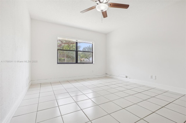 empty room with baseboards, ceiling fan, and a textured ceiling