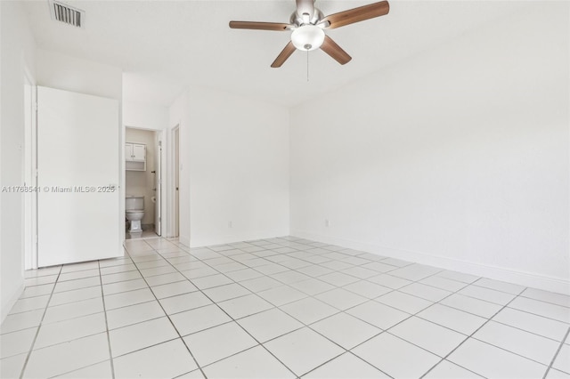 spare room with light tile patterned floors, baseboards, ceiling fan, and visible vents