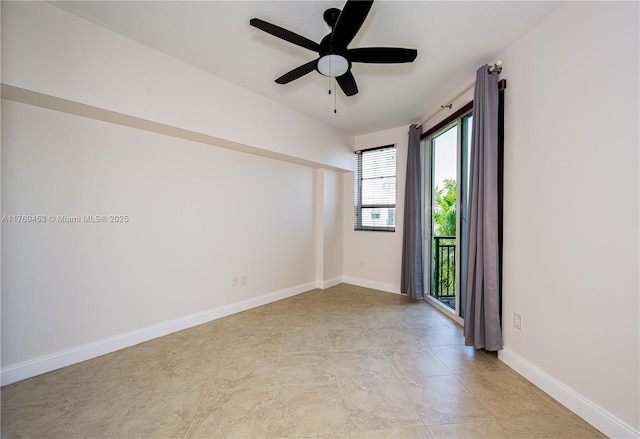 unfurnished room with a ceiling fan and baseboards