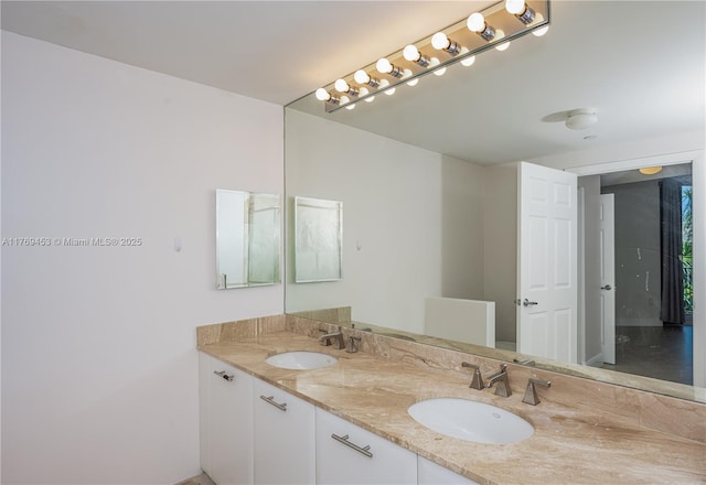 full bath featuring a sink and double vanity