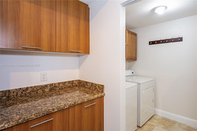 laundry area with washer and dryer, cabinet space, and baseboards