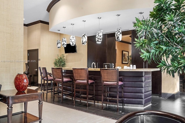 welcome area featuring a towering ceiling and crown molding