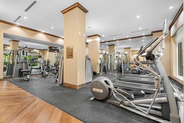 workout area with crown molding, visible vents, and recessed lighting