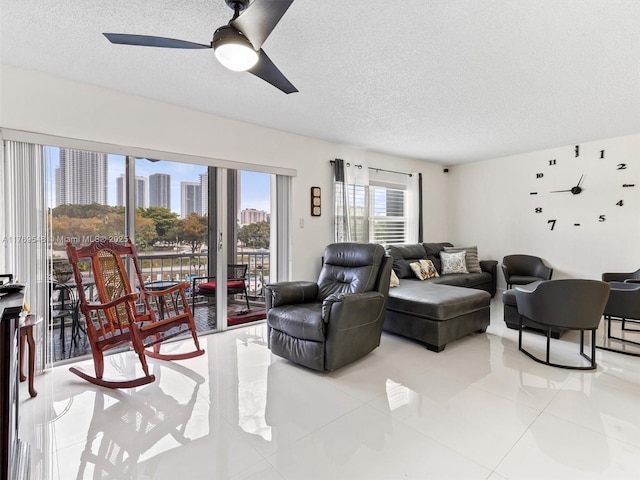 200 Diplomat Pkwy Unit 424, Hallandale Beach, FL 33009 - living area featuring a textured ceiling, a ceiling fan, a view of city, and light tile patterned floors