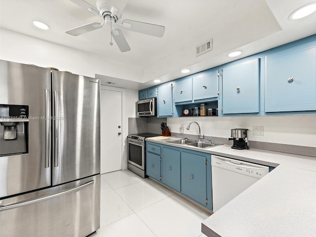 200 Diplomat Pkwy Unit 424, Hallandale Beach, FL 33009 - kitchen featuring light countertops, a sink, blue cabinets, appliances with stainless steel finishes, and visible vents