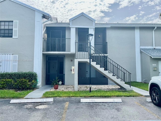 1460 Jefferson Dr Unit H, Homestead, FL 33034 - view of building exterior with uncovered parking and stairs