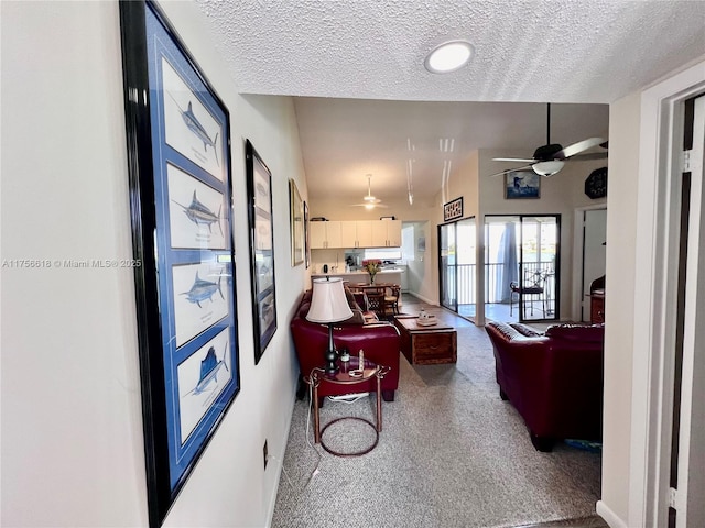 1460 Jefferson Dr Unit H, Homestead, FL 33034 - living area featuring carpet floors, baseboards, ceiling fan, and a textured ceiling