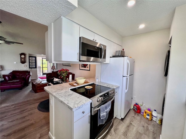 1460 Jefferson Dr Unit H, Homestead, FL 33034 - kitchen featuring white cabinetry, light countertops, stainless steel appliances, and light wood finished floors