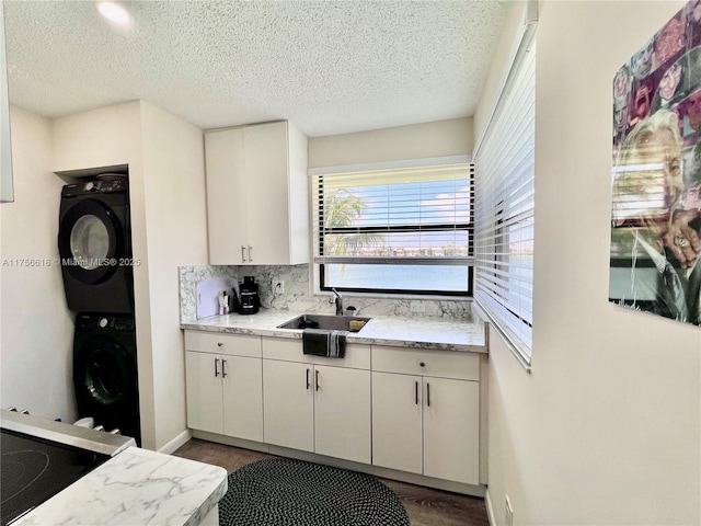 1460 Jefferson Dr Unit H, Homestead, FL 33034 - kitchen with backsplash, white cabinets, stacked washer / dryer, and a sink