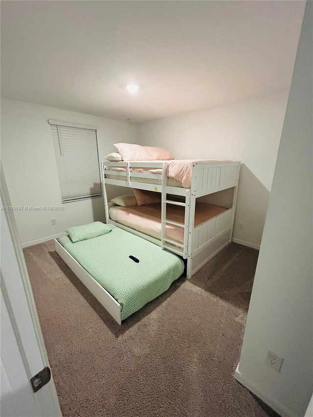 unfurnished bedroom with baseboards and carpet flooring