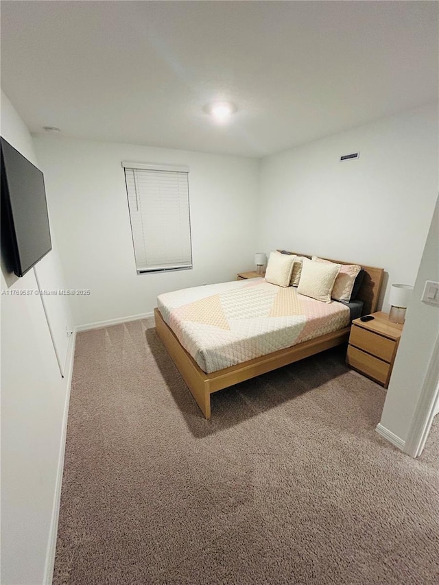 carpeted bedroom with baseboards and visible vents