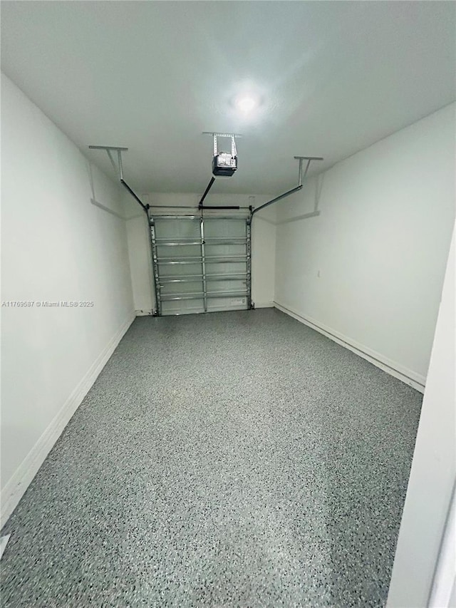 garage with baseboards and a garage door opener