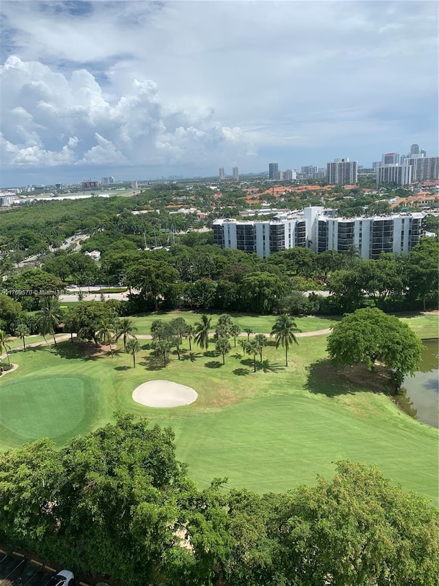 drone / aerial view with a city view and golf course view