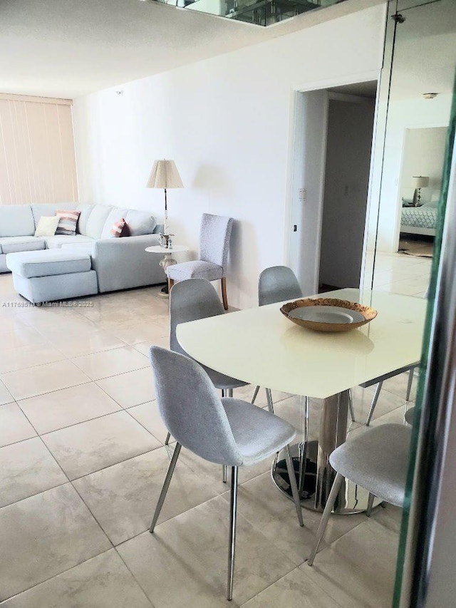 dining space featuring light tile patterned floors