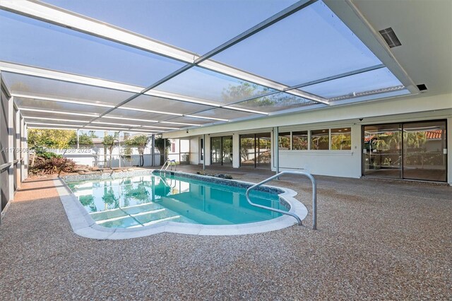 outdoor pool with a lanai and a patio