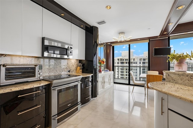 4000 Island Blvd Unit Ph6, Aventura, FL 33160 - kitchen featuring white cabinets, stainless steel appliances, a toaster, and decorative backsplash