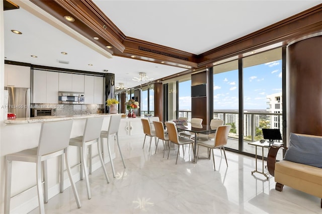 4000 Island Blvd Unit Ph6, Aventura, FL 33160 - kitchen featuring white cabinetry, tasteful backsplash, crown molding, modern cabinets, and appliances with stainless steel finishes